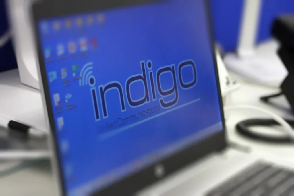 Indigo-branded laptop set up on a desk