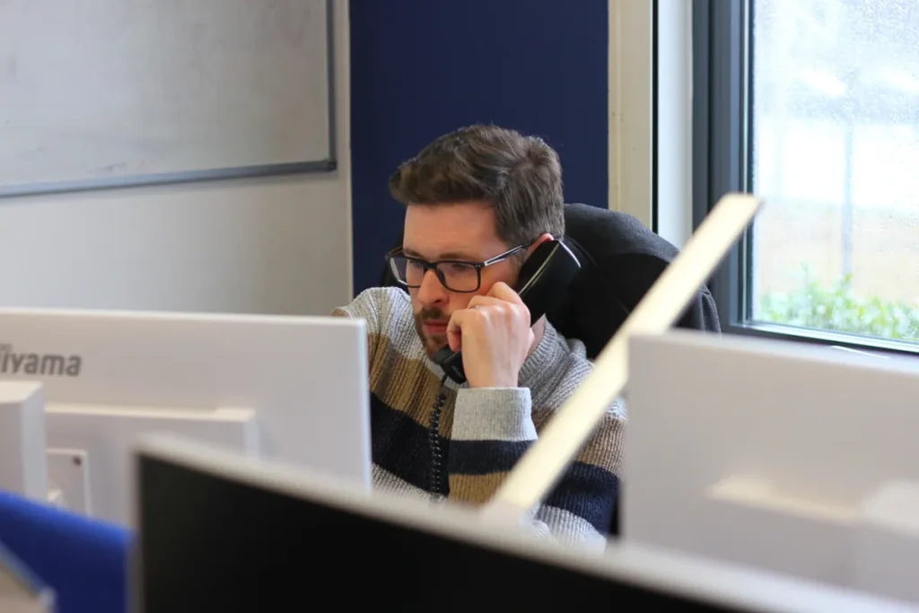 Indigo team member on a call at his desk